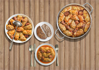 Gourmet Stuffed Pickled Cabbage Rolls Cooked With Pork Dry Cured Ham And Smoked Ribs Served With Integral Brown Bread On Wooden Rustic Slatted Place Mat