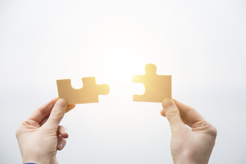 business people assembling jigsaw puzzle and represent team support and help concept. Building a business success. Concept for consulting, marketing, business, strategy and planning. 