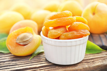 Dried apricots on fresh fruits background, selective focus, toned