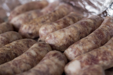 raw sausages in a shell for grilling