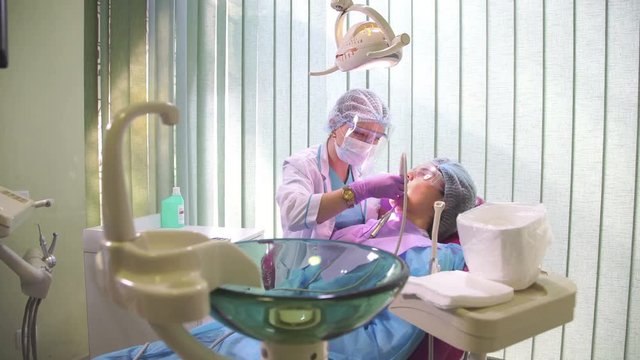 Dentist Works With Patients