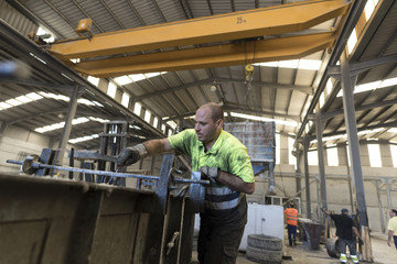 Man measuring and hammering concrete structure for create a construction piece