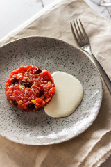 Beef tartare with pine nuts. Top view. Laying vertical