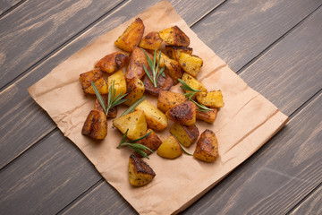 potatoes baked with spices and rosemary on paper