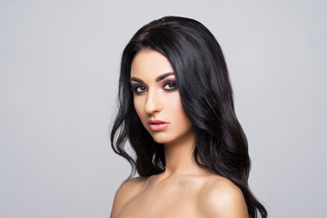 Naklejka premium Beauty close-up portrait of beautiful, fresh and healthy woman. Human face over grey background
