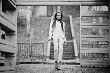Stylish african american girl with dreads outdoor.