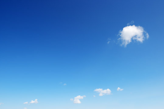 Small white cloud on background bright blue sky.