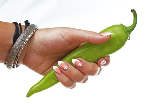 Woman Hand Holding Green Hot Pepper On Isolated White Cutout Background. Studio Photo With Studio Lighting Easy To Use For Every Concept.