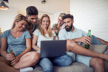 Friends watching TV at home