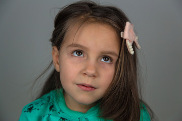 Cute little girl dreaming and thinking beautiful things