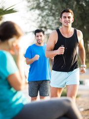 Smiling sportsmen are joggning race in time warm-up