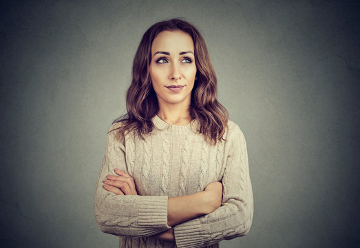 Woman looking offended while posing on gray