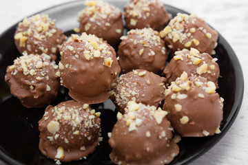 Handmade chocolate sweets sprinkled with walnuts