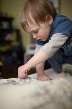 Boy coloring with crayons