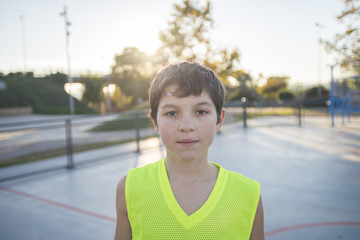 Portrait of a young teen wearing a yellow basketball sleeveless