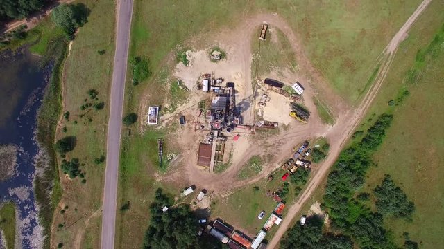 Aerial top view of the oil gas drilling tower in forest