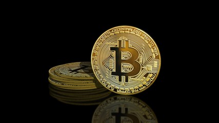 Bitcoin coin - golden Bitcoin coins on black mirror surface