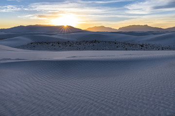 Sun rays over desert mountains at sunset