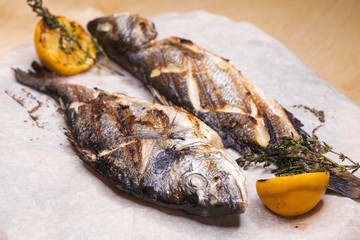 Restaurant dish two grilled fish Dorado and Seabass