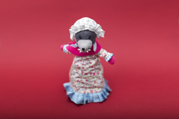 Big bad wolf dressed in grandma clothes cute rag or fabric doll isolated on a red background