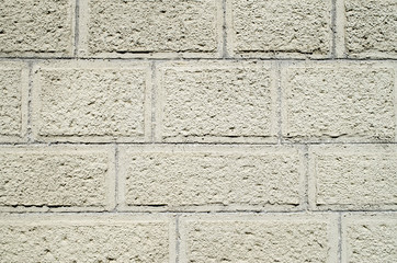 Ecru wall of concrete blocks with plaster