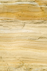 Naklejka na ściany i meble A yellow sandstone with cracks closeup
