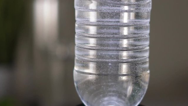 Slow motion. Gas bubbles float in a plastic bottle with drinking water. device for hydrogen rhenium in action. HD
