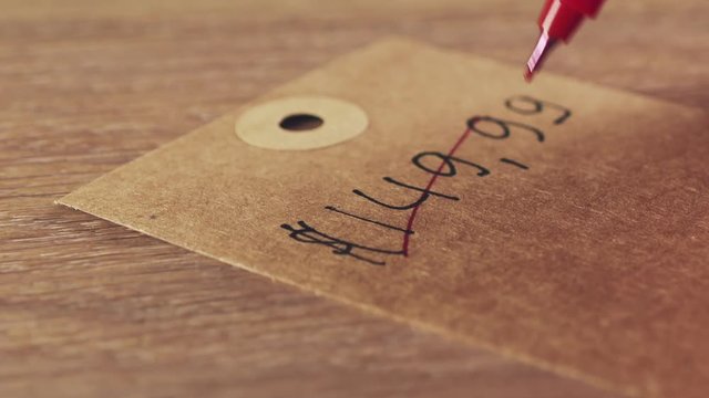 female teenage girl write price 59,9 over 149 us dollars on label