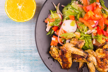 Fried chicken wings in the Caribbean with orange