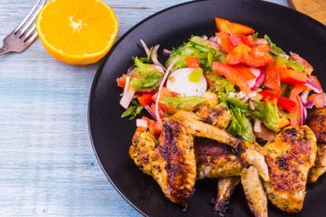 Fried chicken wings in the Caribbean with orange