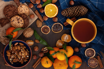 Winter comfort food - chocolate cookies, nuts, tangerines and tea