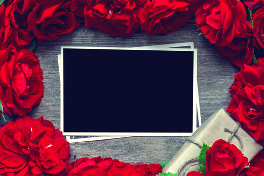 blank photo card in frame made of red roses flowers and gift box