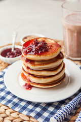 Pancakes stack on a plate with raspberry jam. Shrove Tuesday, pancake day, Maslenitsa. Traditional Russian holiday