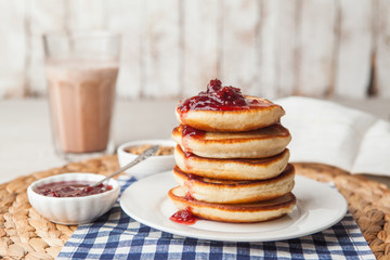Pancakes stack on a plate with raspberry jam. Shrove Tuesday, pancake day. Maslenitsa. Traditional Russian holiday