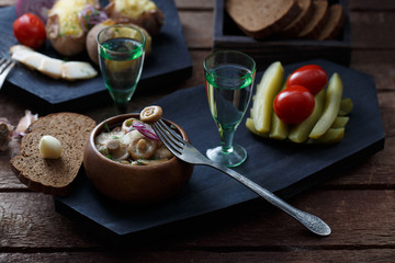 Two shots of vodka and a variety of snacks for it