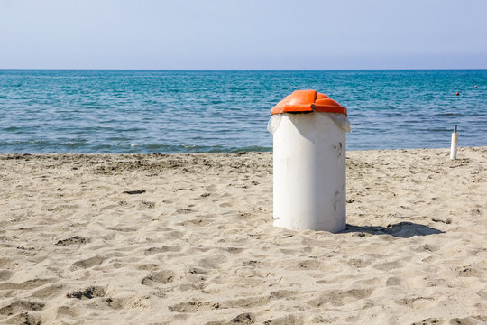 Trash can on the beach sunny day. Concept photo of a clean beach