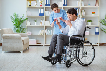 Disabled patient on wheelchair visiting doctor for regular check