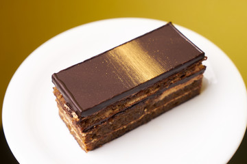 Opera cake slice on a white plate