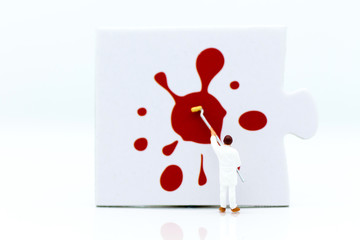 Miniature people: Workers are painting color on the puzzle. Image use for business concept.