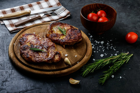 Fresh grilled meat  with spices on dark  background