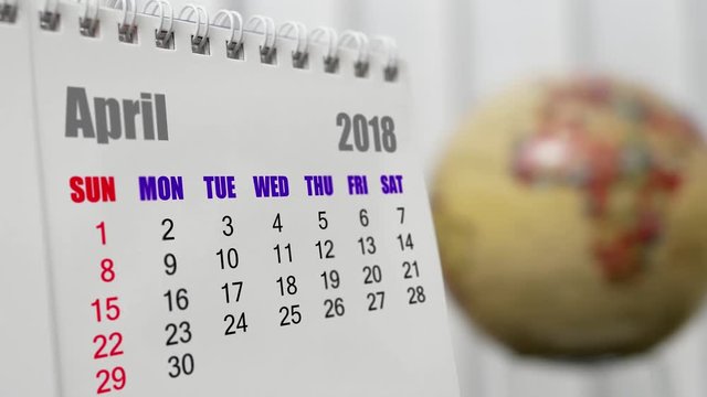 Motion of April 2018 calendar with blur earth globe turning background
