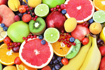 Crate of fresh ripe sweet fruits: apple, orange, grapefruit, qiwi, banana, lime, blueberry, strawberry, raspberry, peach, cherry; selective focus