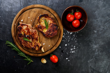 Fresh grilled meat  with spices on dark  background, top view.