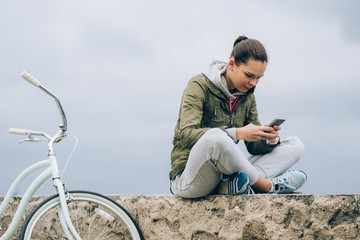 Girl in sportswear using a mobile phone