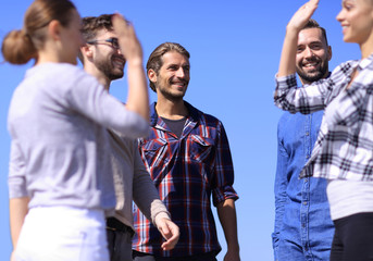 friends students giving each other a high five.