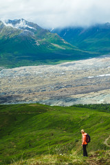 Naklejka premium Woman hiking in the mountains. Enjoying the view. Active life. Alaska range. Glacier.