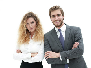 two young business people stand with arms folded