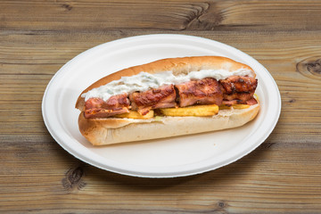 Delicious, long sandwich with bacon on plate