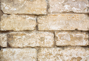 Close-up photo of the aged rough stone wall for background	