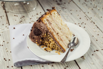 Dark chocolate vegan cake with candies and nuts on wooden background